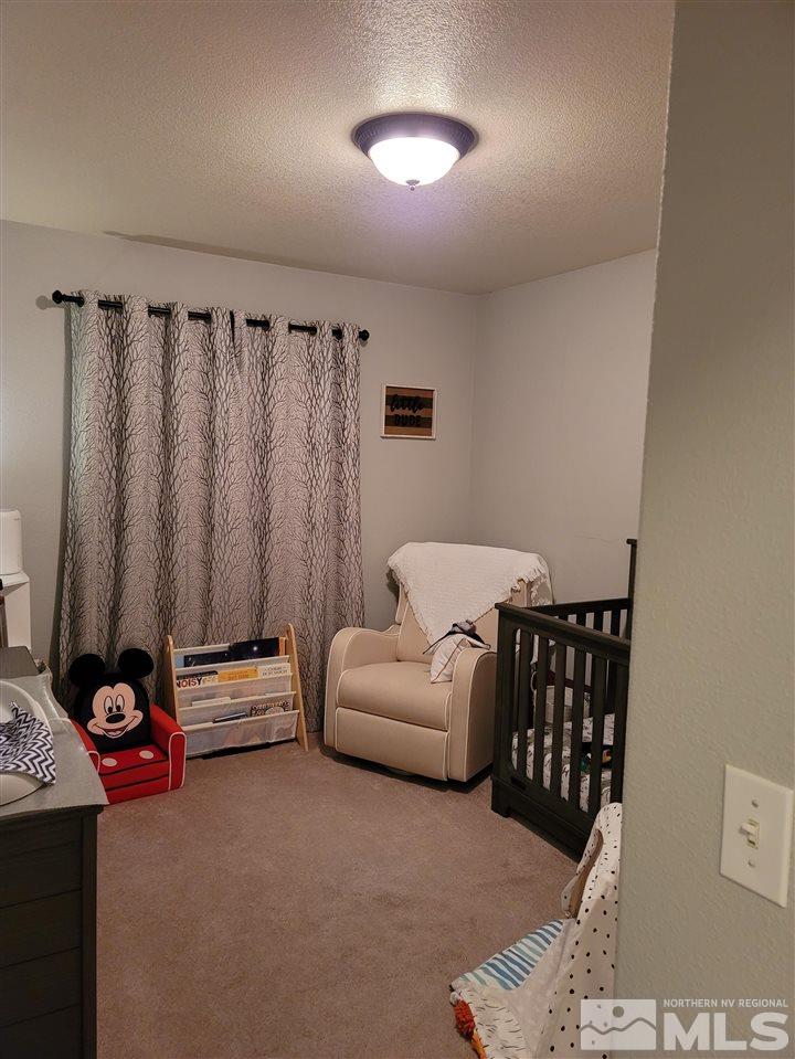 17756 Fortune Court Reno, NV 89508 - Photo 14 of 28 a bedroom with furniture and a window