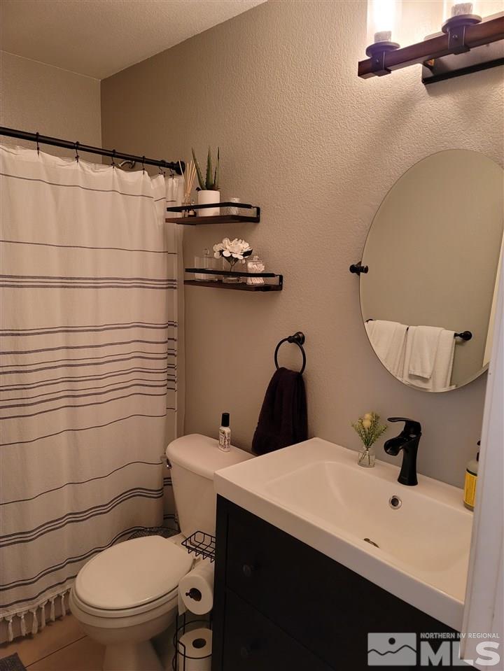 17756 Fortune Court Reno, NV 89508 - Photo 15 of 28 a bathroom with a sink a toilet and mirror