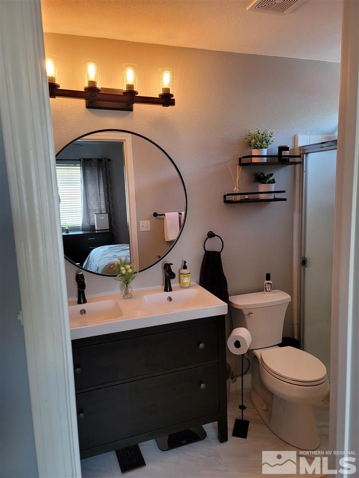 17756 Fortune Court Reno, NV 89508 - Photo 24 of 28 a bathroom with a toilet sink and mirror