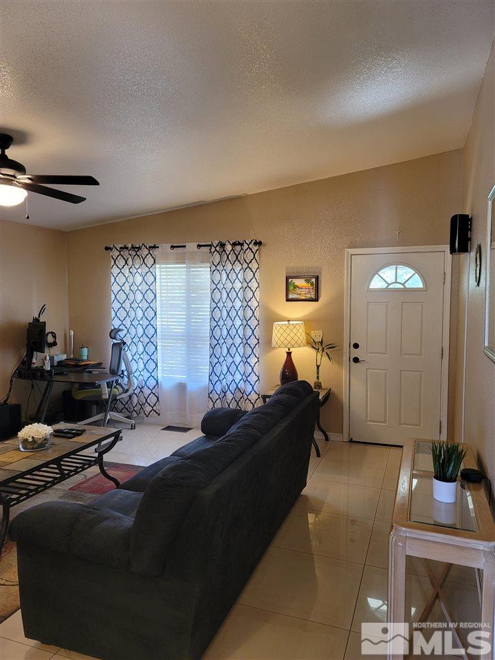 17756 Fortune Court Reno, NV 89508 - Photo 6 of 28 a living room with furniture and a flat screen tv