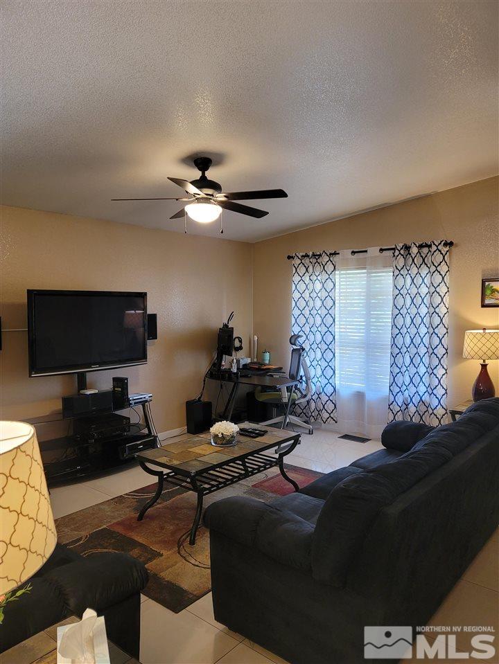17756 Fortune Court Reno, NV 89508 - Photo 7 of 28 a living room with furniture and a flat screen tv