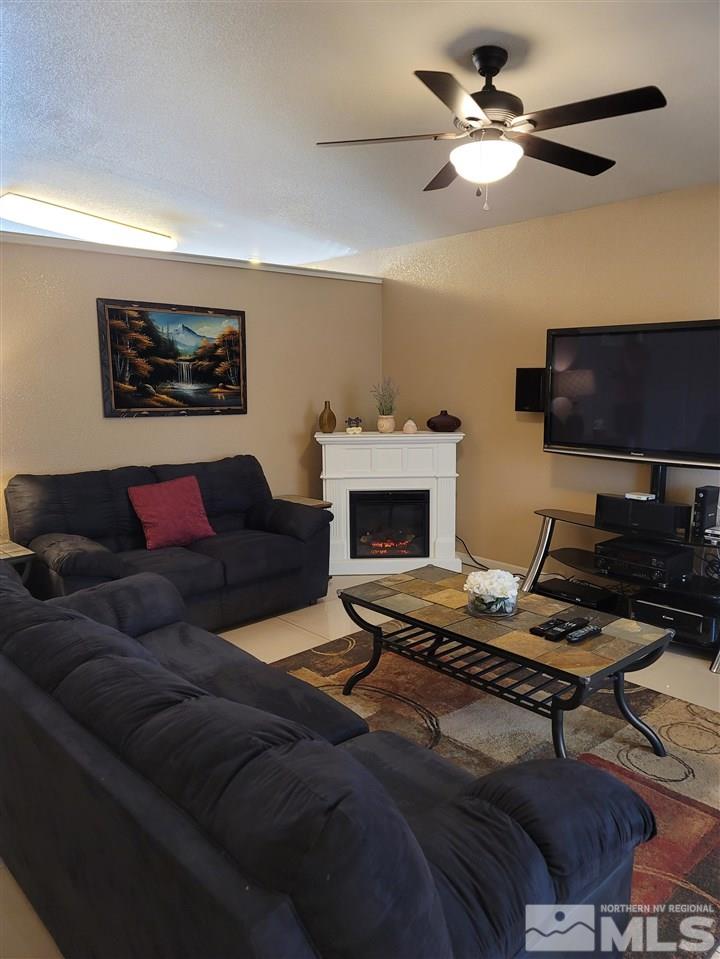 17756 Fortune Court Reno, NV 89508 - Photo 8 of 28 a living room with furniture a fireplace and a flat screen tv