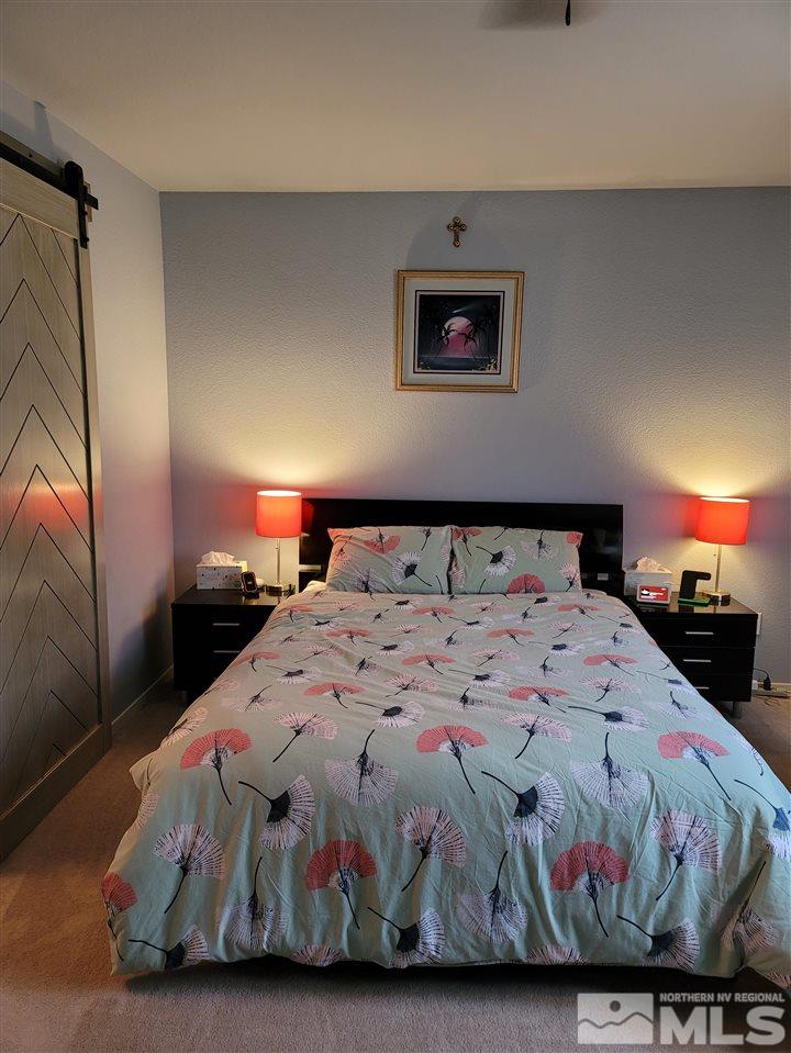 17756 Fortune Court Reno, NV 89508 - Photo 10 of 28 a bedroom with a bed and a lamp