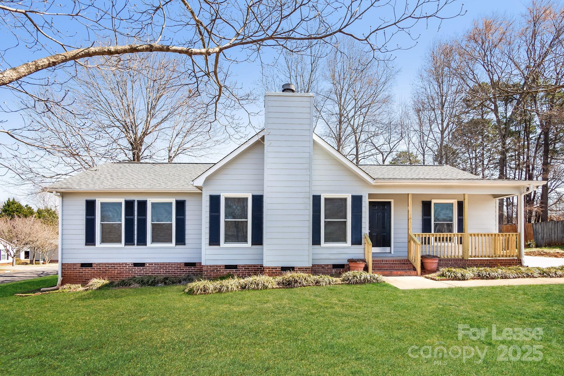 a view of a house with a backyard