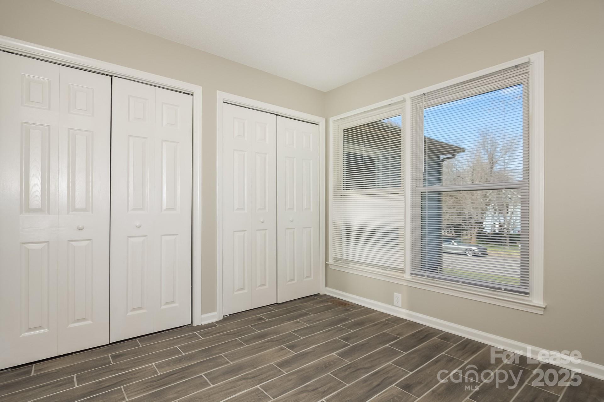 124 Shade Tree Court Gastonia, NC 28056 - Photo 11 of 16 a view of an empty room with wooden floor and a window