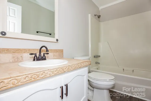 a bathroom with a sink a toilet and a bathtub