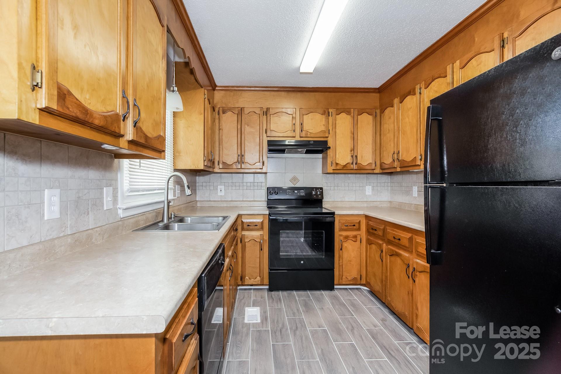 124 Shade Tree Court Gastonia, NC 28056 - Photo 5 of 16 a kitchen with stainless steel appliances granite countertop a stove a sink and a refrigerator