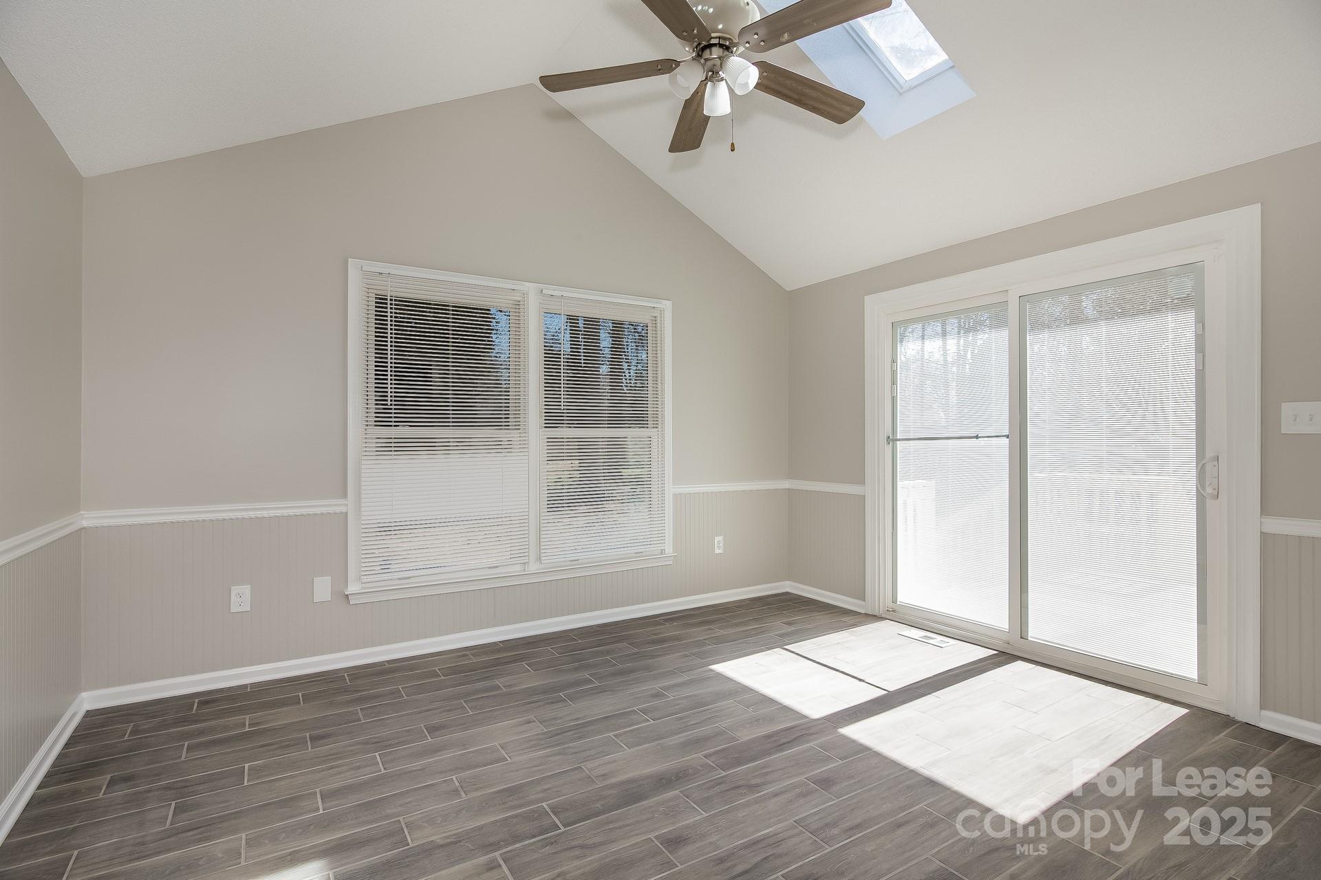 124 Shade Tree Court Gastonia, NC 28056 - Photo 7 of 16 an empty room with wooden floor and windows