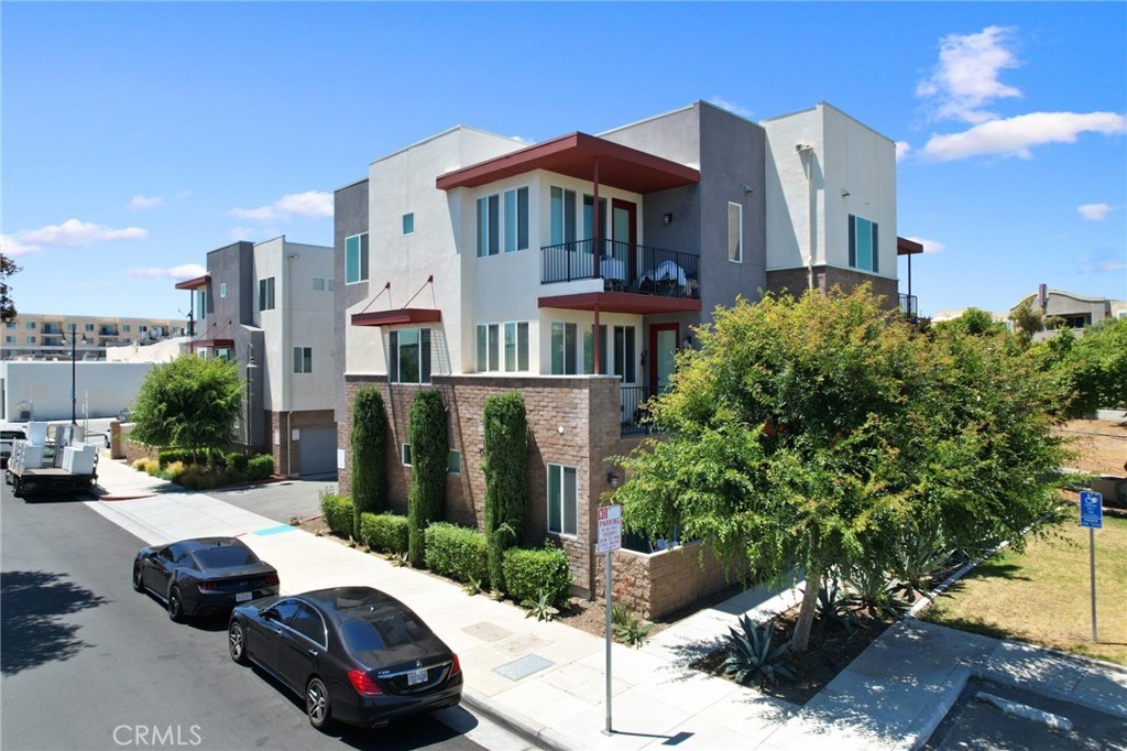 a view of a white house with a yard and sitting area