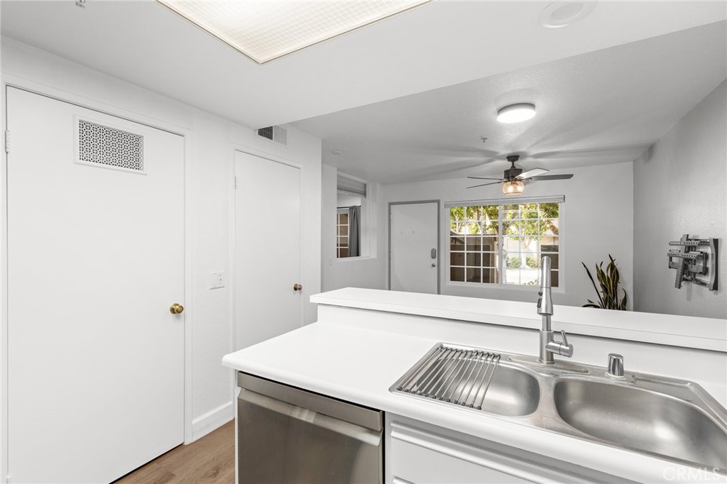 2800 Keller Drive, Unit 262 Tustin, CA 92782 - Photo 11 of 41 a close view of a sink and dishwasher with wooden floor