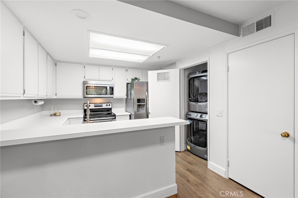 2800 Keller Drive, Unit 262 Tustin, CA 92782 - Photo 12 of 41 a kitchen with stainless steel appliances a refrigerator and a stove top oven