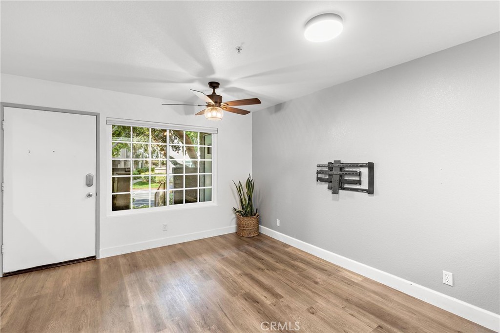 2800 Keller Drive, Unit 262 Tustin, CA 92782 - Photo 13 of 41 an empty room with wooden floor and windows