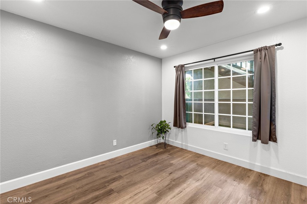 2800 Keller Drive, Unit 262 Tustin, CA 92782 - Photo 15 of 41 an empty room with wooden floor and windows
