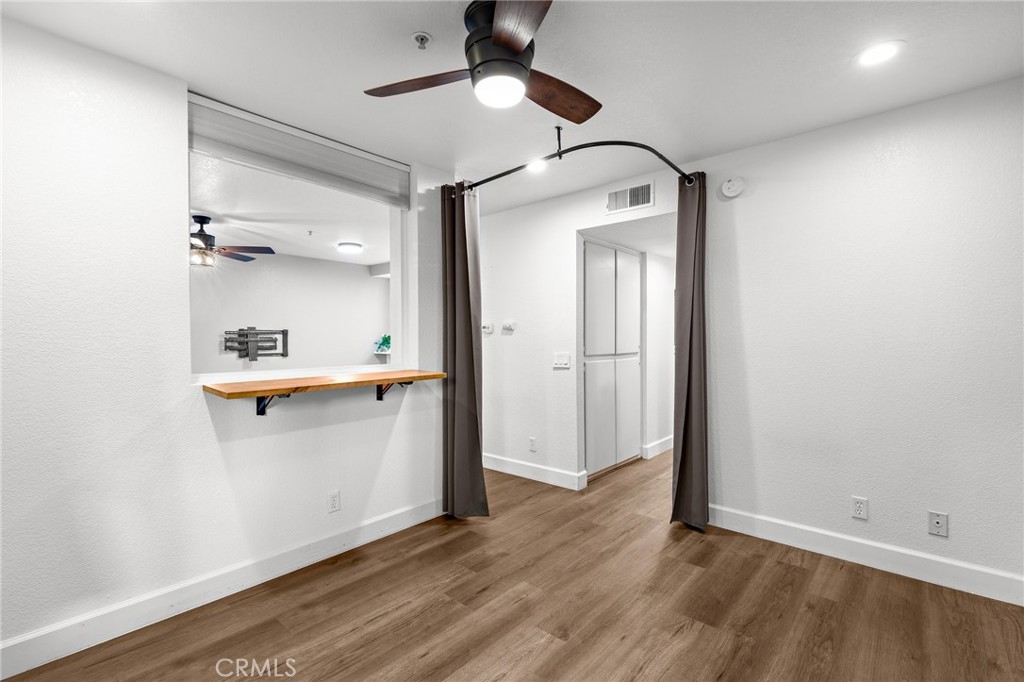 2800 Keller Drive, Unit 262 Tustin, CA 92782 - Photo 17 of 41 a view of a hallway with wooden floor and cabinet