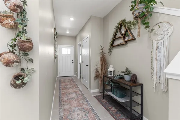 a view of a hallway to a livingroom with furniture