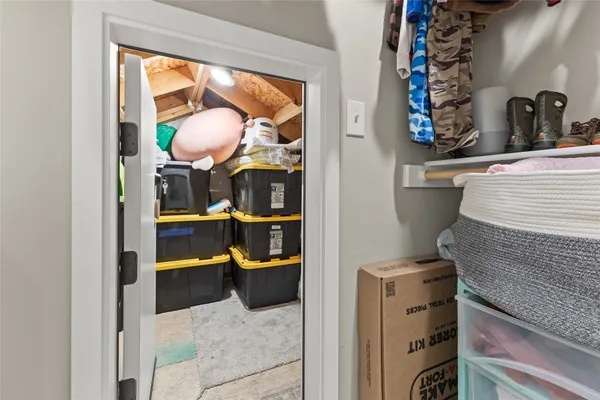 a view of walk in closet with clothes