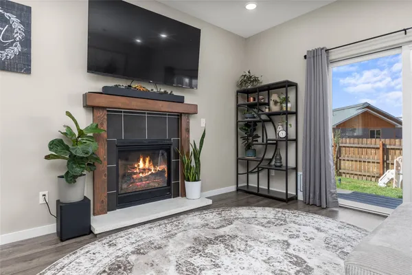 a living room with furniture a bookshelf and a fireplace