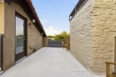 a balcony with table and chairs