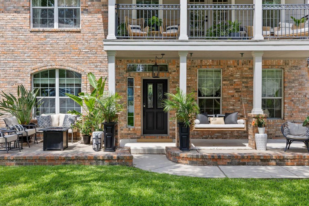 6704 Kiev Cove Austin, TX 78739 - Photo 11 of 37 An inviting brick facade offers a welcoming entry with a charming porch swing and upper-level balcony access.