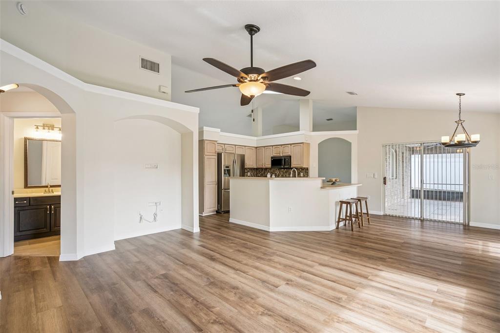 893 Watt Circle Deltona, FL 32738 - Photo 11 of 34 a view of a living room and kitchen with wooden floor