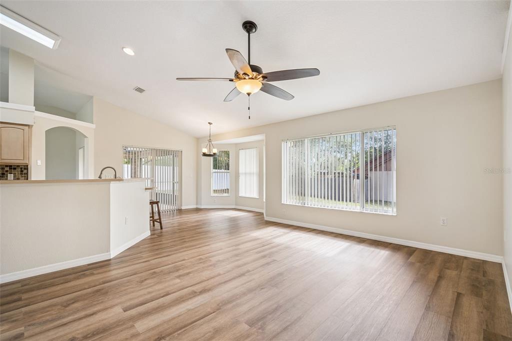 893 Watt Circle Deltona, FL 32738 - Photo 16 of 34 a view of an empty room with window and wooden floor