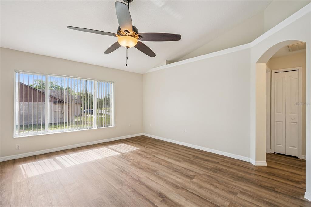 893 Watt Circle Deltona, FL 32738 - Photo 17 of 34 a view of an empty room with wooden floor and a window