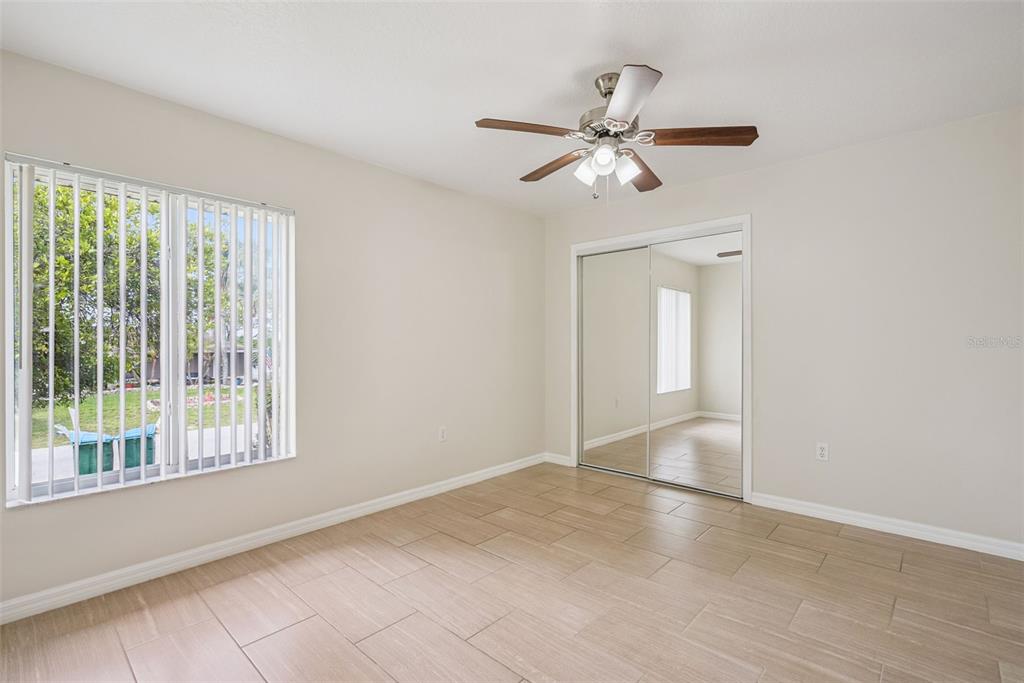 893 Watt Circle Deltona, FL 32738 - Photo 18 of 34 a view of an empty room with chandelier fan and a window