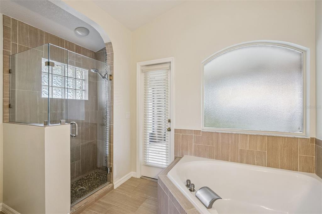893 Watt Circle Deltona, FL 32738 - Photo 20 of 34 a bathroom with a tub and shower