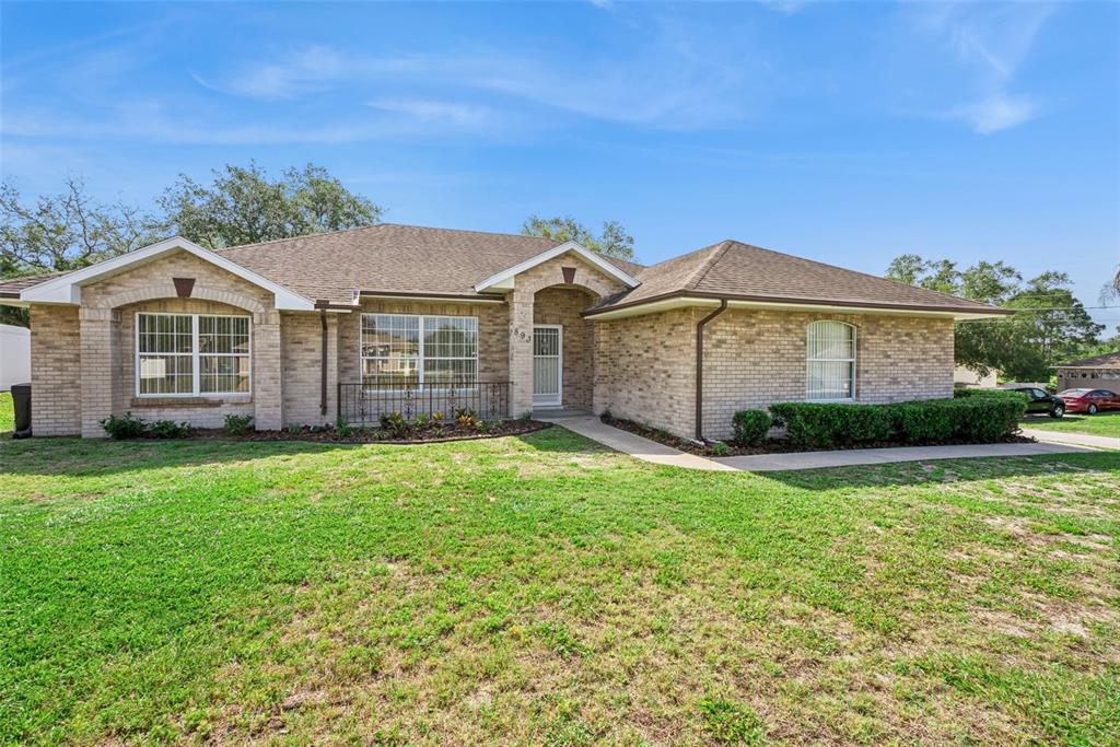 893 Watt Circle Deltona, FL 32738 - Photo 2 of 34 front view of a house with a yard