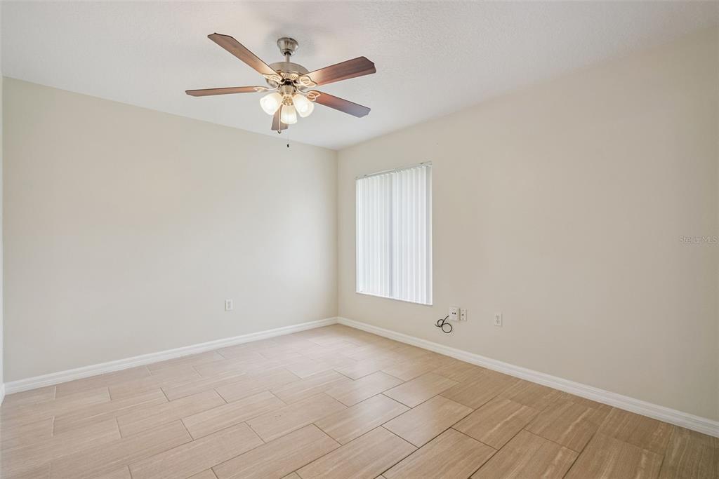 893 Watt Circle Deltona, FL 32738 - Photo 23 of 34 an empty room with a window and a fan