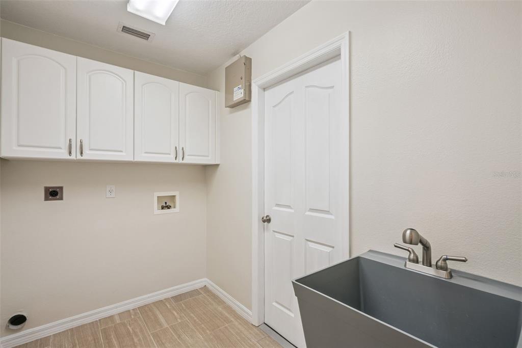 893 Watt Circle Deltona, FL 32738 - Photo 25 of 34 a bathroom with a sink and cabinets