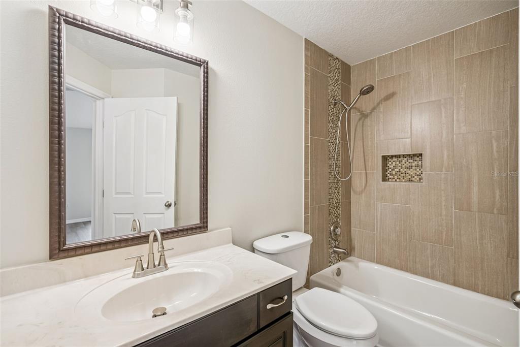 893 Watt Circle Deltona, FL 32738 - Photo 26 of 34 a bathroom with a sink toilet tub and shower