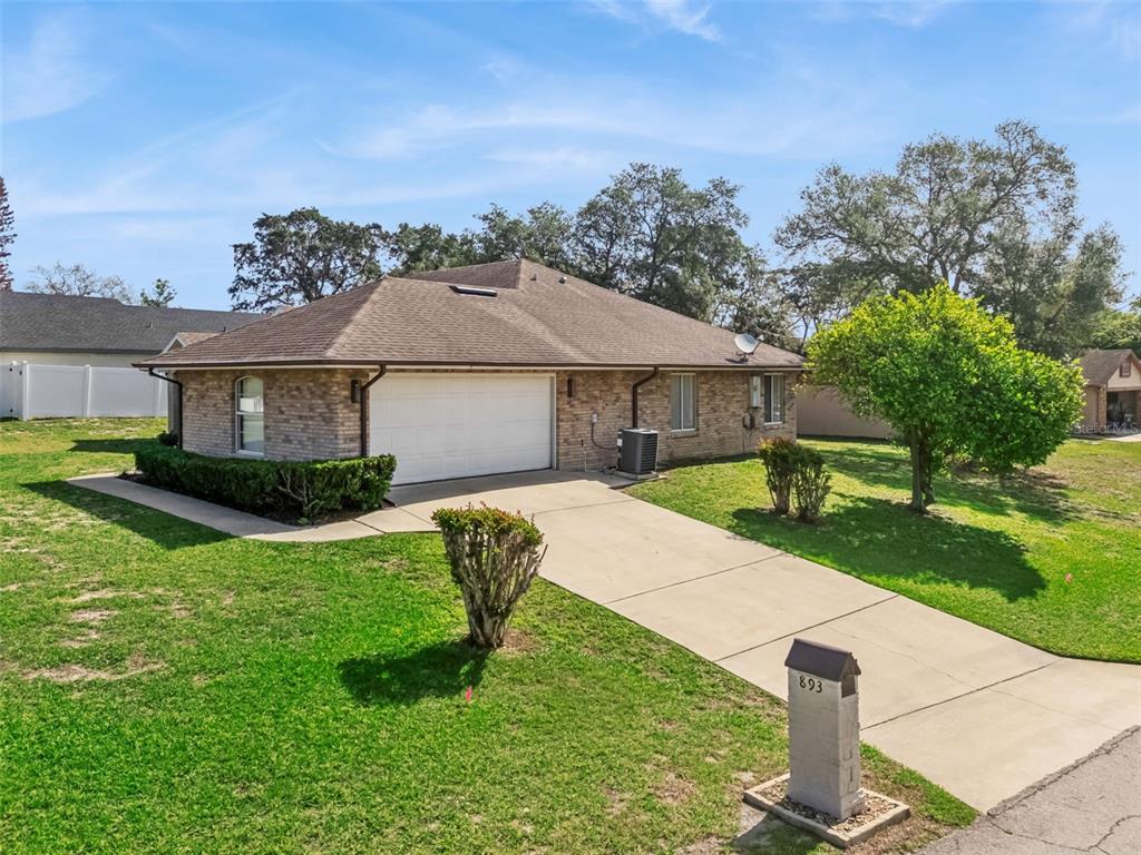 893 Watt Circle Deltona, FL 32738 - Photo 29 of 34 a house with garden in front of it
