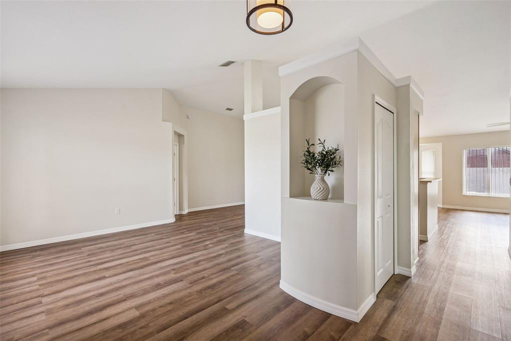 893 Watt Circle Deltona, FL 32738 - Photo 3 of 34 a view of a hallway with wooden floor and staircase