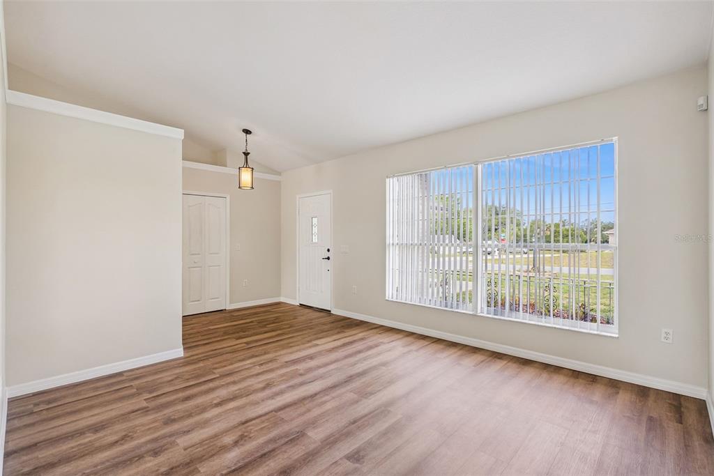 893 Watt Circle Deltona, FL 32738 - Photo 5 of 34 a view of an empty room with wooden floor and a window