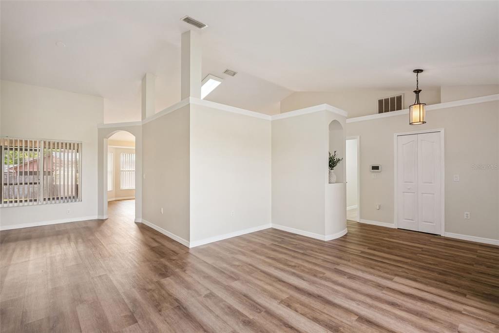 893 Watt Circle Deltona, FL 32738 - Photo 6 of 34 a view of an empty room with wooden floor and a window