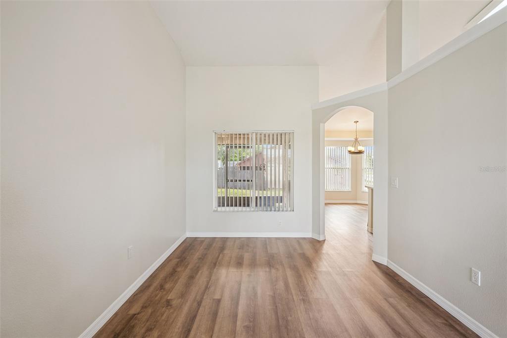 893 Watt Circle Deltona, FL 32738 - Photo 8 of 34 a view of an empty room with wooden floor and a window