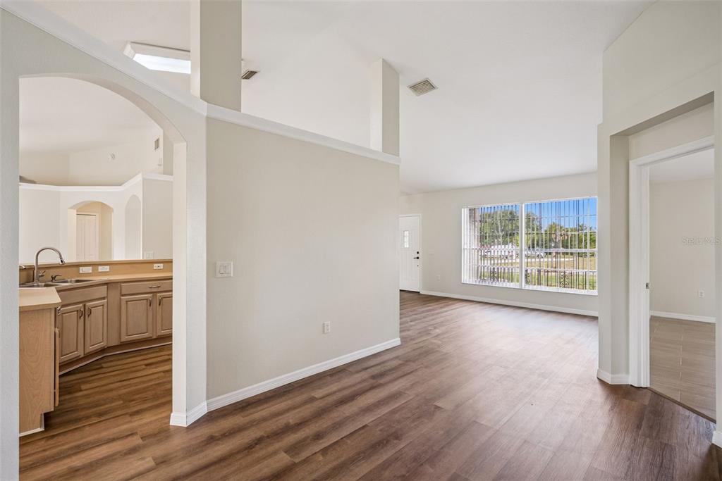 893 Watt Circle Deltona, FL 32738 - Photo 9 of 34 a view of a kitchen with wooden floor and a ceiling fan