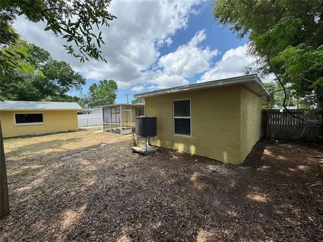 a backyard of a house with table and chairs