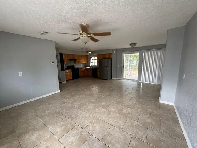a view of a livingroom with furniture and a ceiling fan