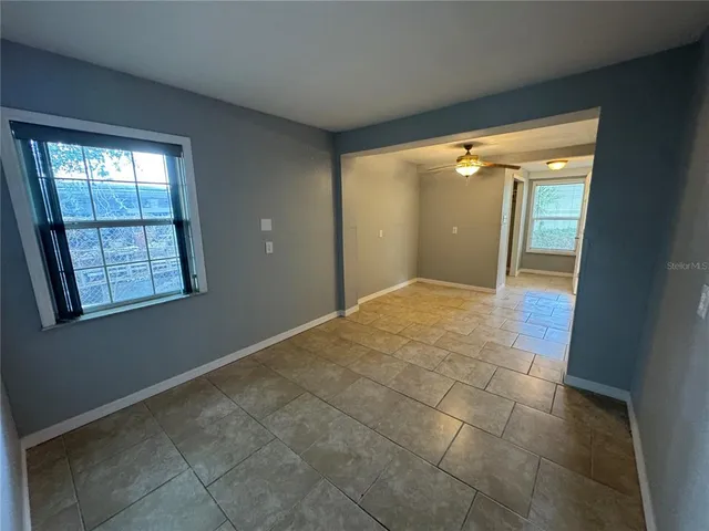 an empty room with windows and entrance