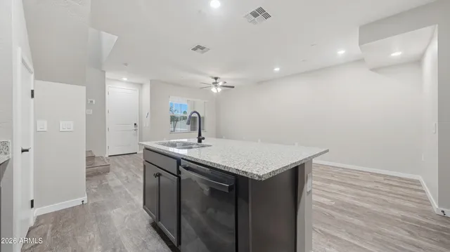 a kitchen with a sink a refrigerator and a stove top oven