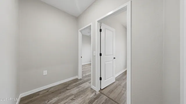 an empty room with a window and ceiling fan