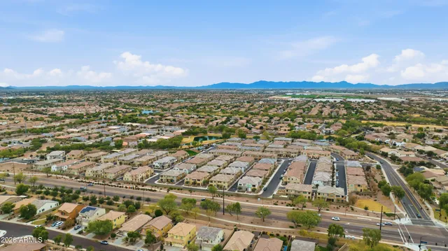 a view of a city with lawn chairs and large tree