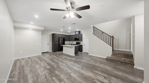 a kitchen that has a sink a refrigerator a microwave and cabinets
