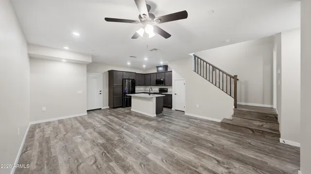 a large kitchen with stainless steel appliances kitchen island a large counter top and a stove top oven