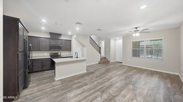a view of kitchen with furniture and wooden floor