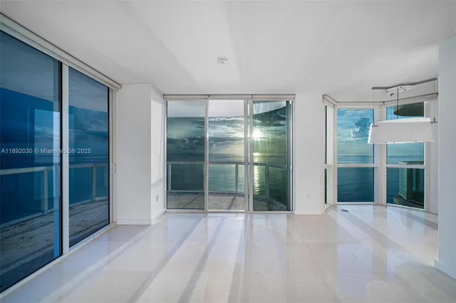 a view of empty room with a large window