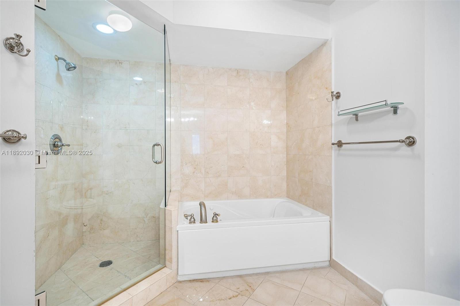 6365 Collins Avenue, Unit 2901 Miami Beach, FL 33141 - Photo 23 of 44 a white bath tub sitting next to a shower