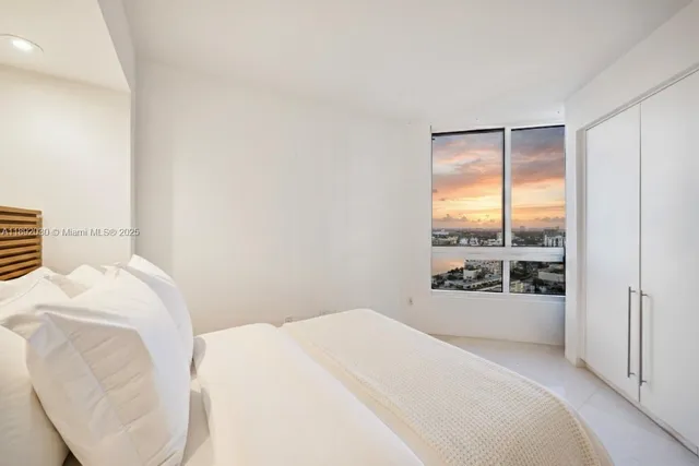 a bathroom with a sink shower and a mirror